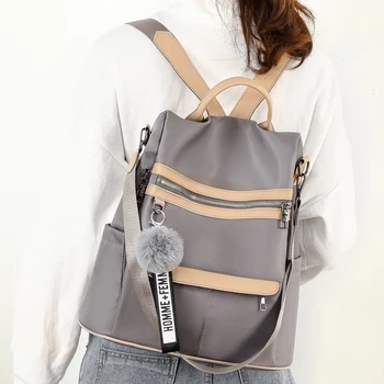 2020 la calidad de nueva mochila impermeable anti-robo de tela Oxford simple de la universidad de viento de la bolsa de juventud de la niña de la mochila de regalo colgante de bolas de pelo